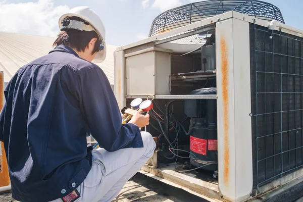 technician-is-checking-air-conditioner-measuring-equipment-filling-air-conditioner
